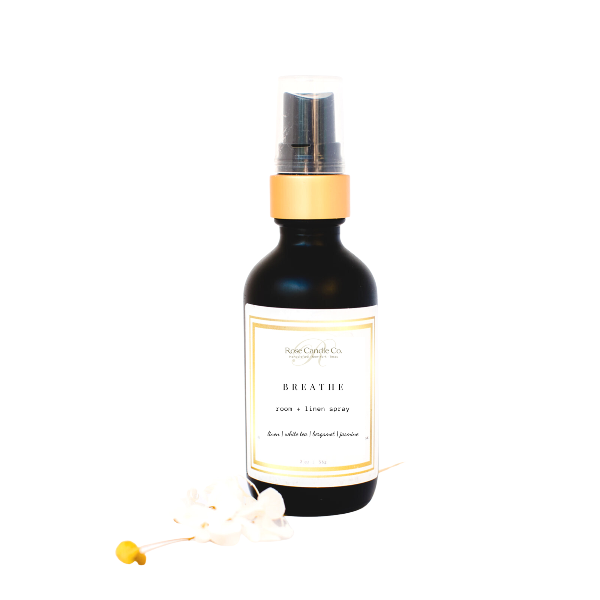 Breathe Room + Linen Spray in a black matte glass bottle with a gold rimmed sprayer