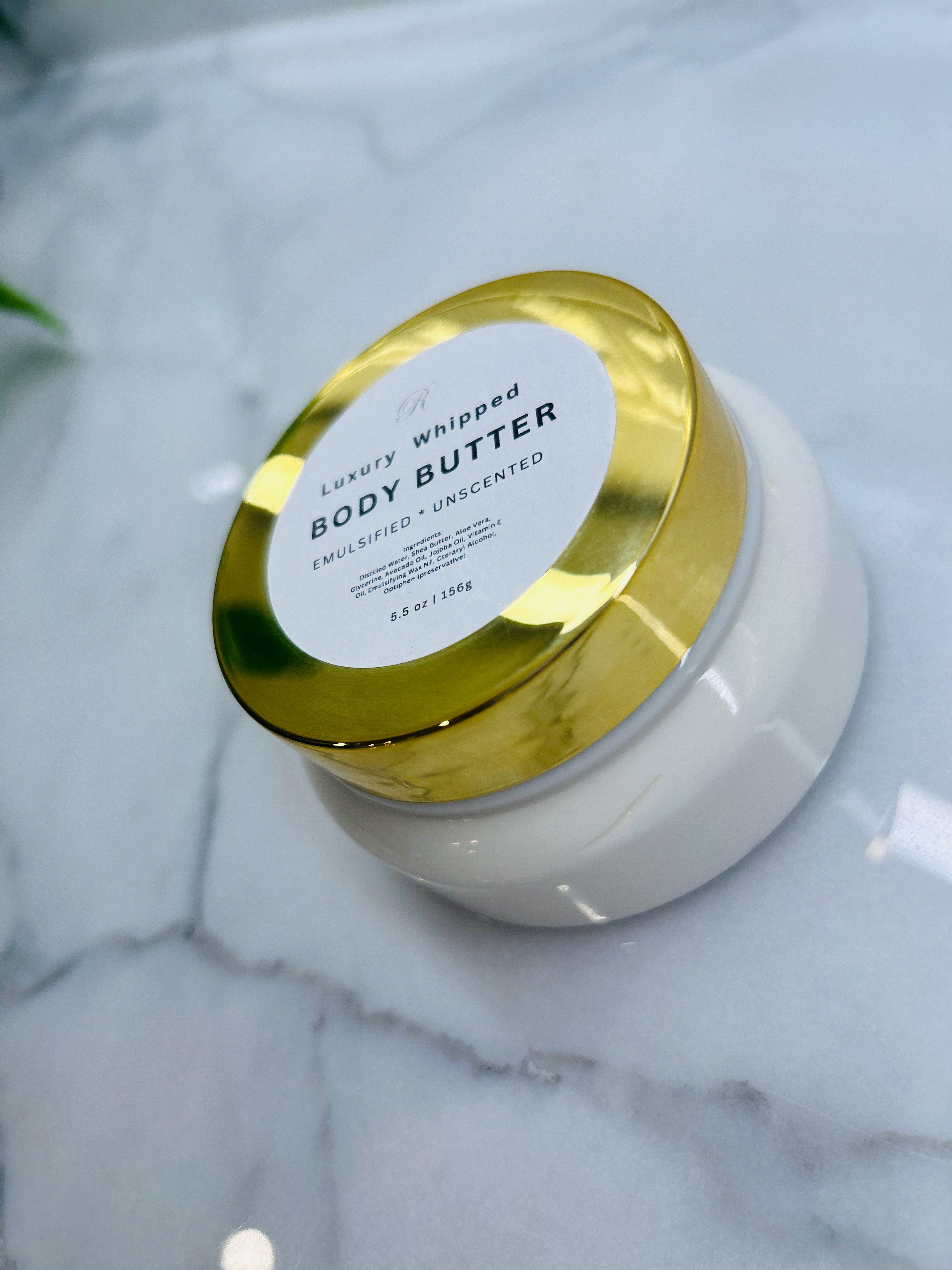 Luxury whipped body butter in a white jar with gold lid