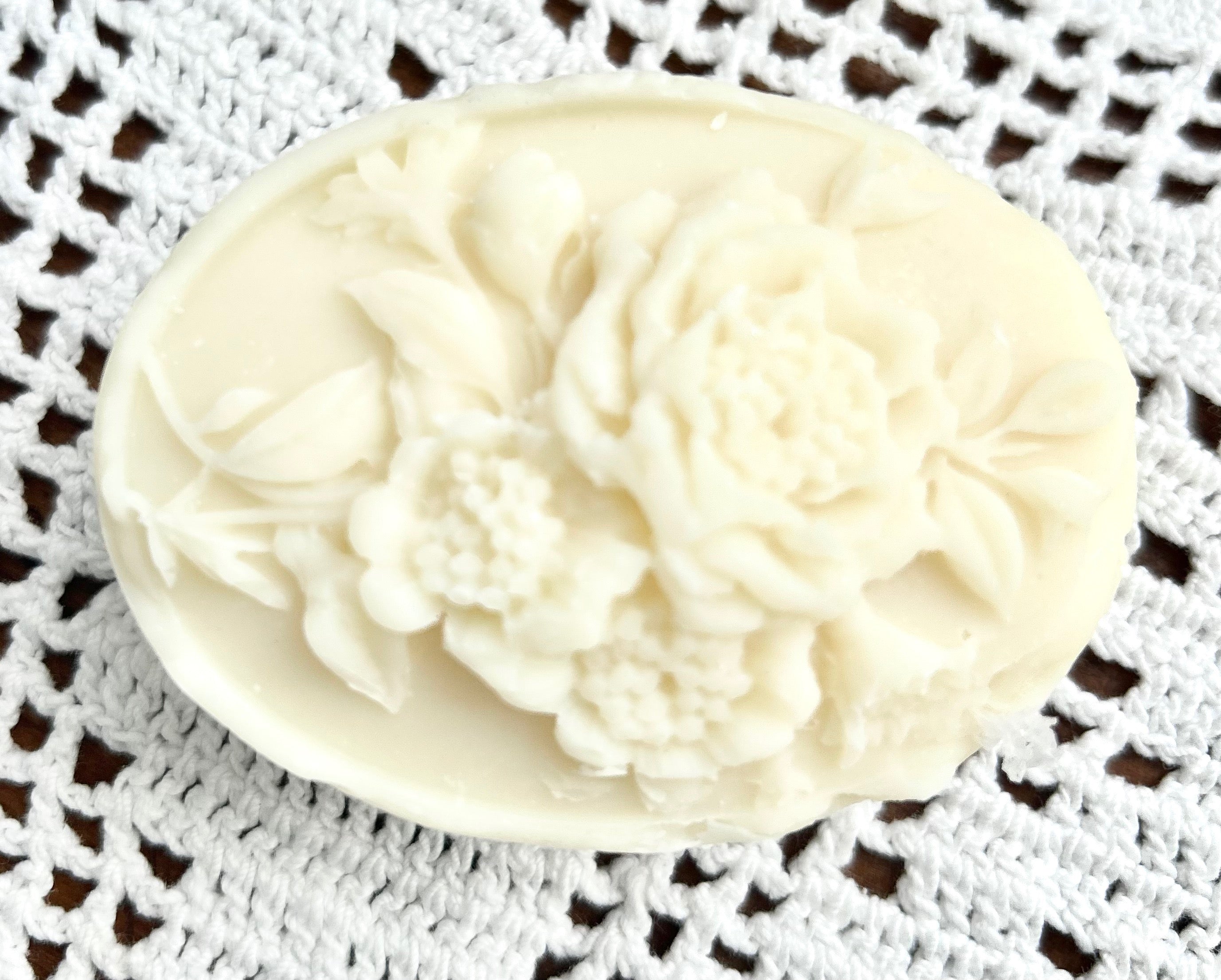 designer rose candle on a piece of laced crochet doily